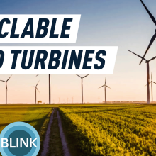 Wind turbines in a field at sunset.