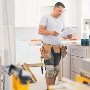 A contractor working on fitting a new kitchen