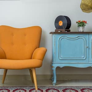 Retro armchair with antique sideboard