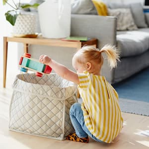  Girl sitting on the floor taking toys out of a box