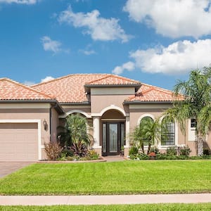 Large house with garage and palm trees