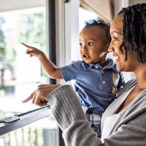 mother and toddler looking out the window