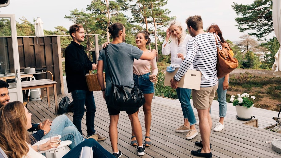 Friends greeting each other on cottage deck