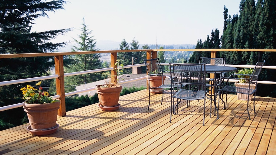 A metal table and chairs on a wooden deck