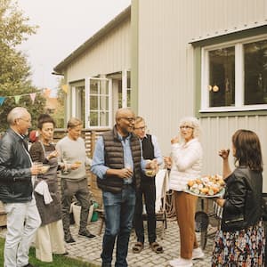 Group of seniors enjoying a backyard barbecue at a friend’s house  