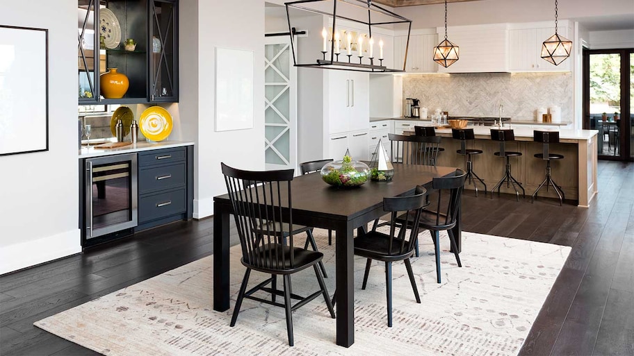 Black dining table and chairs in open concept room