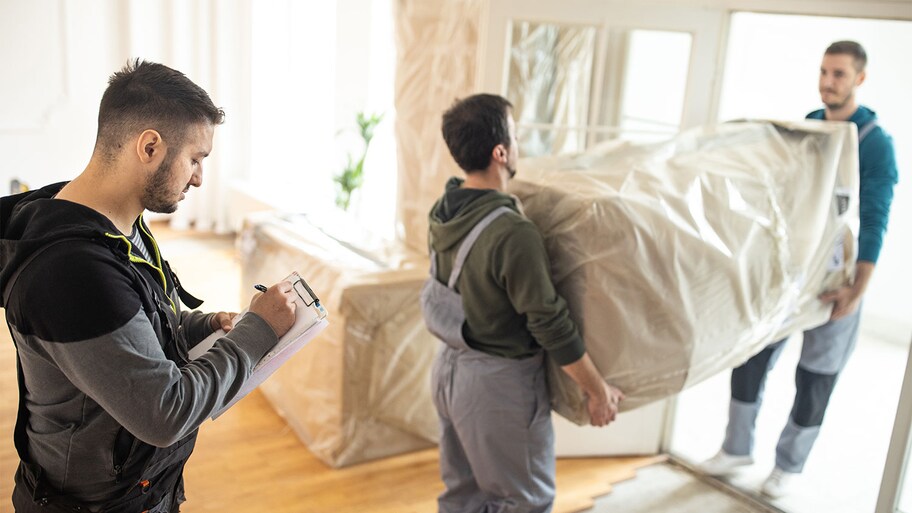 professional movers carrying out furniture 