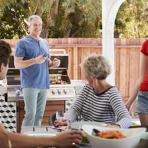 Family eating outside at a table on their back patio 