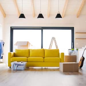 Moving boxes and a yellow sofa in a living room