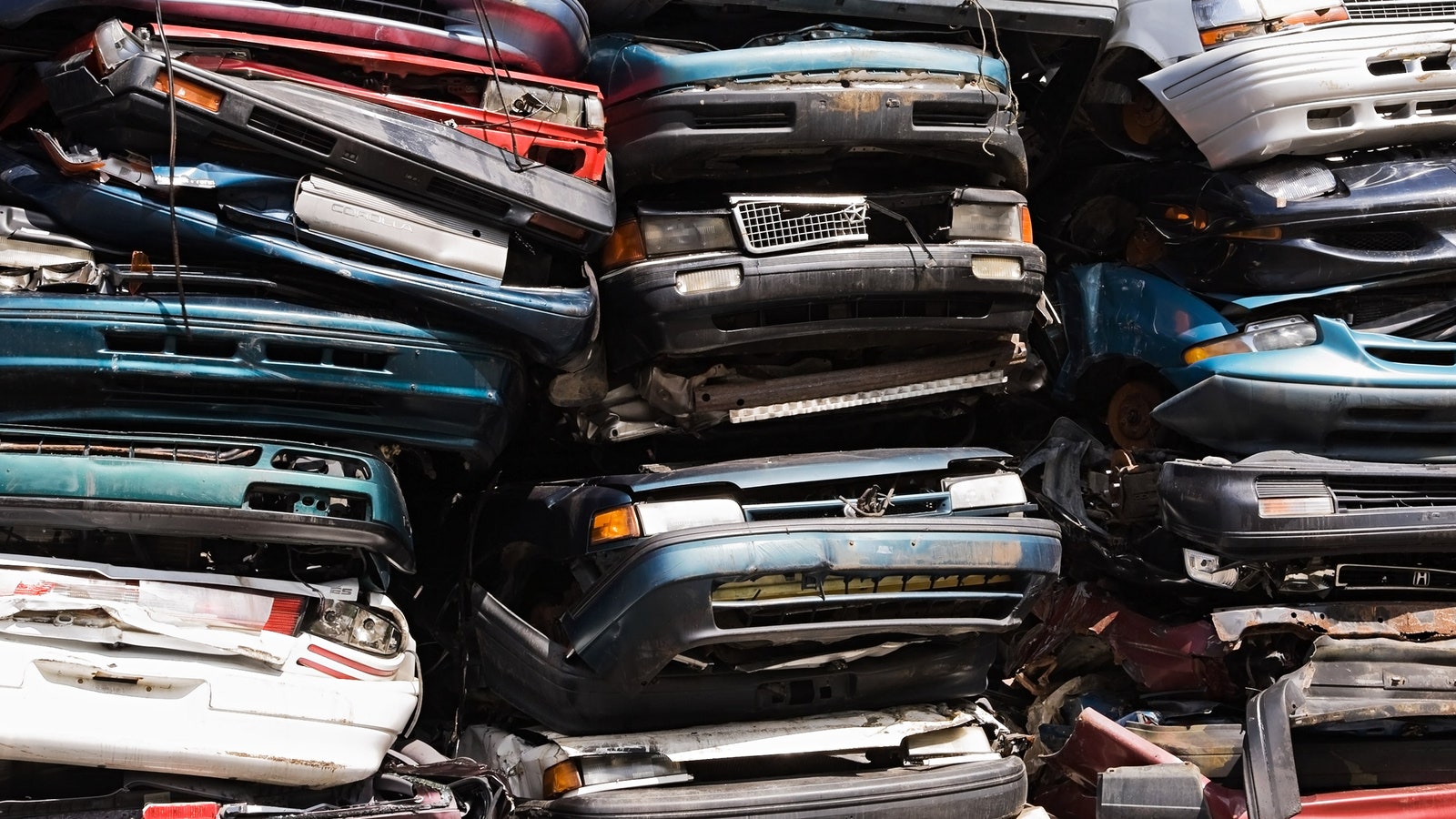 Crushed old cars stacked on top on each other