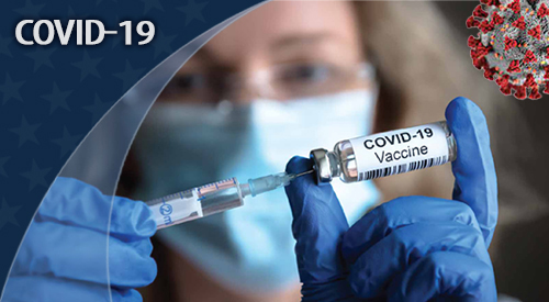 Health care working filling syringe with COVID-19 vaccine