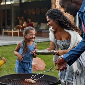 A family of four grilling their backyard