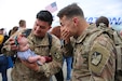 Families and friends gather at the Roland R. Wright Air Base to greet the approximately 100 Soldiers from Echo Battery, 1st Battalion, 145th Field Artillery, “Big Red” as they returned from a 10-month Middle East deployment April 9.