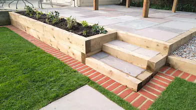 Patio steps leading to an edged lawn