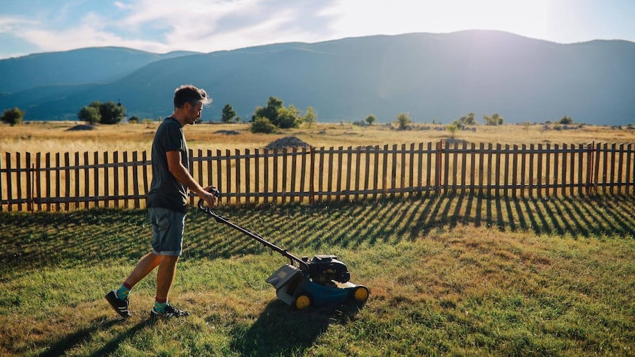 A man mowing the lawn of his garden