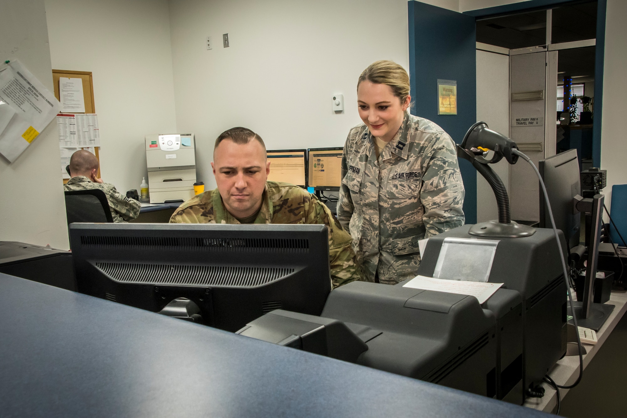 Military members view information on a computer