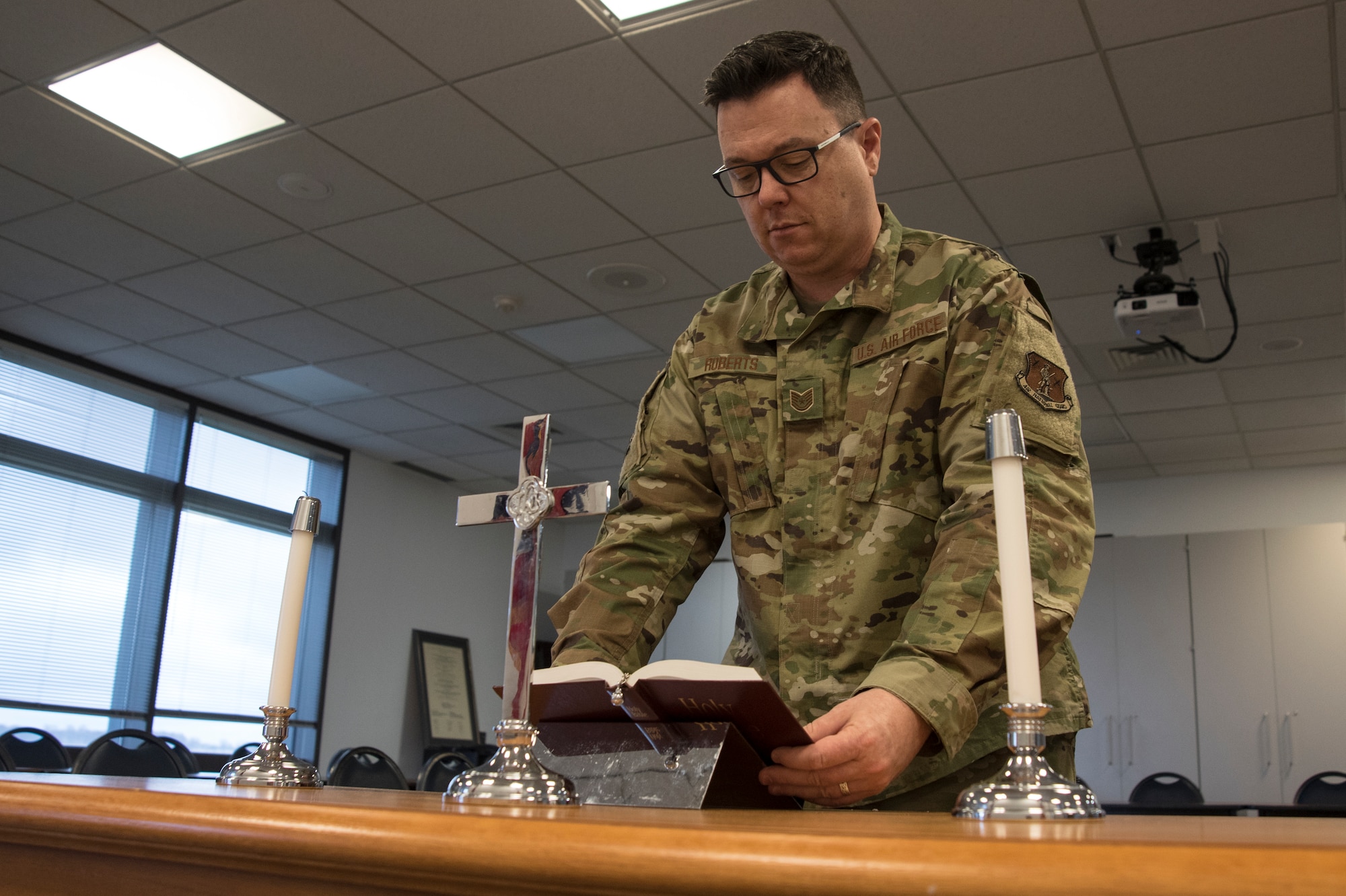 Military member prepares a bible for church service