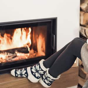 Woman in front of fireplace