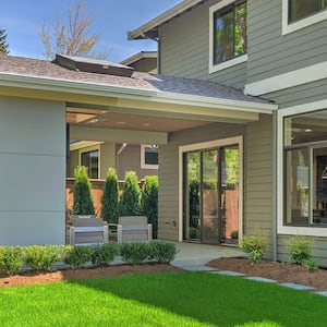 grey house with porch and backyard