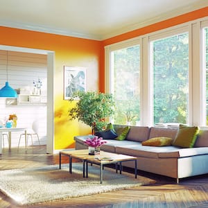 Brightly orange painted livingroom with white trim