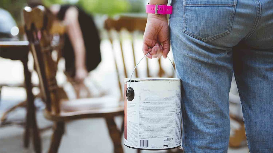 woman carrying leftover paint for new project 