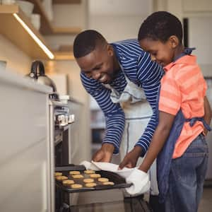 father and son baking cookies 