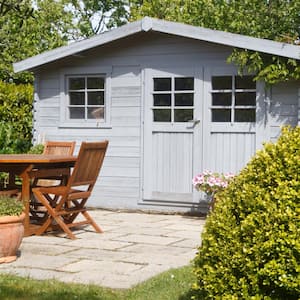 A shed with terrace and wooden garden furniture