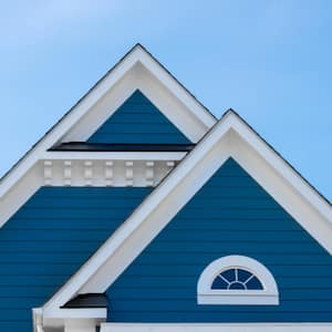 House with vinyl siding painted blue