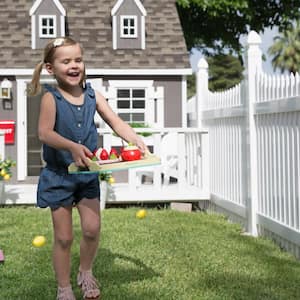 A happy girl holding tray with toys