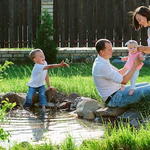 family playing by private pond