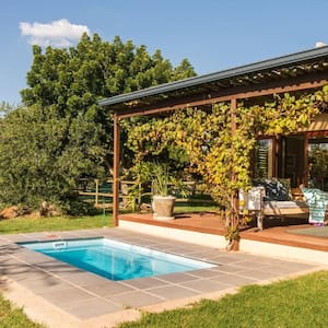 A guest house with a patio and a small pool