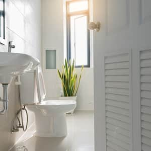 Door opened into bathroom with toilet and sink in view