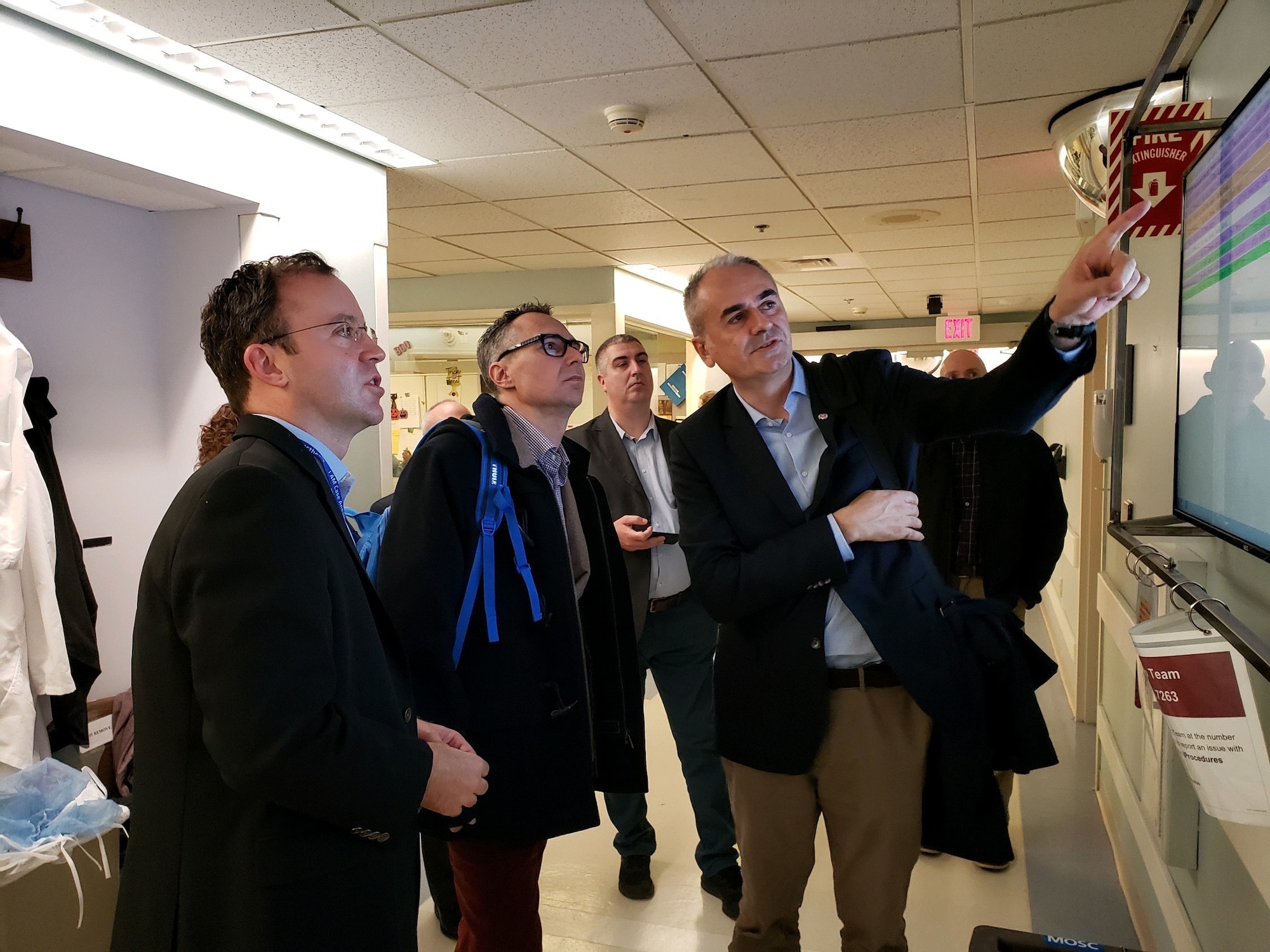 Military members view monitors while on a tour.