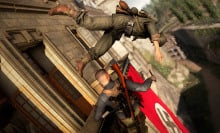 A screenshot from "Sniper Elite 5." Karl Fairburne is seen pulling a Nazi soldier out of a window.