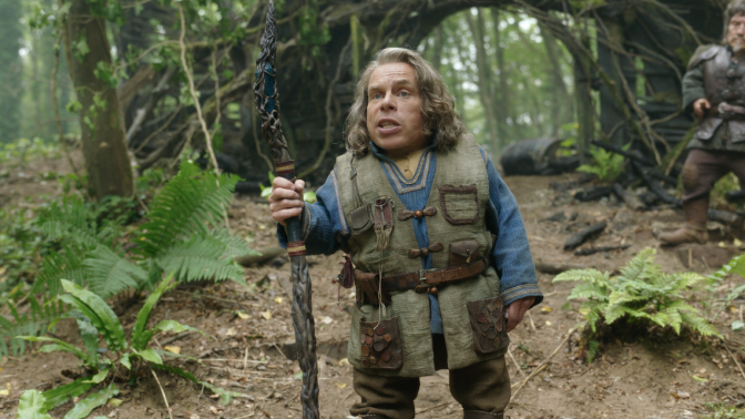 A still from the Disney+ series "Willow" featuring Warwick Davis in costume as Willow.