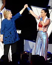 Hillary Clinton and Perry pose with hands connected at a fundraising concert