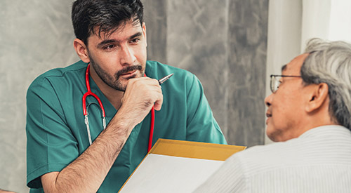 Young provider is talking with elderly man