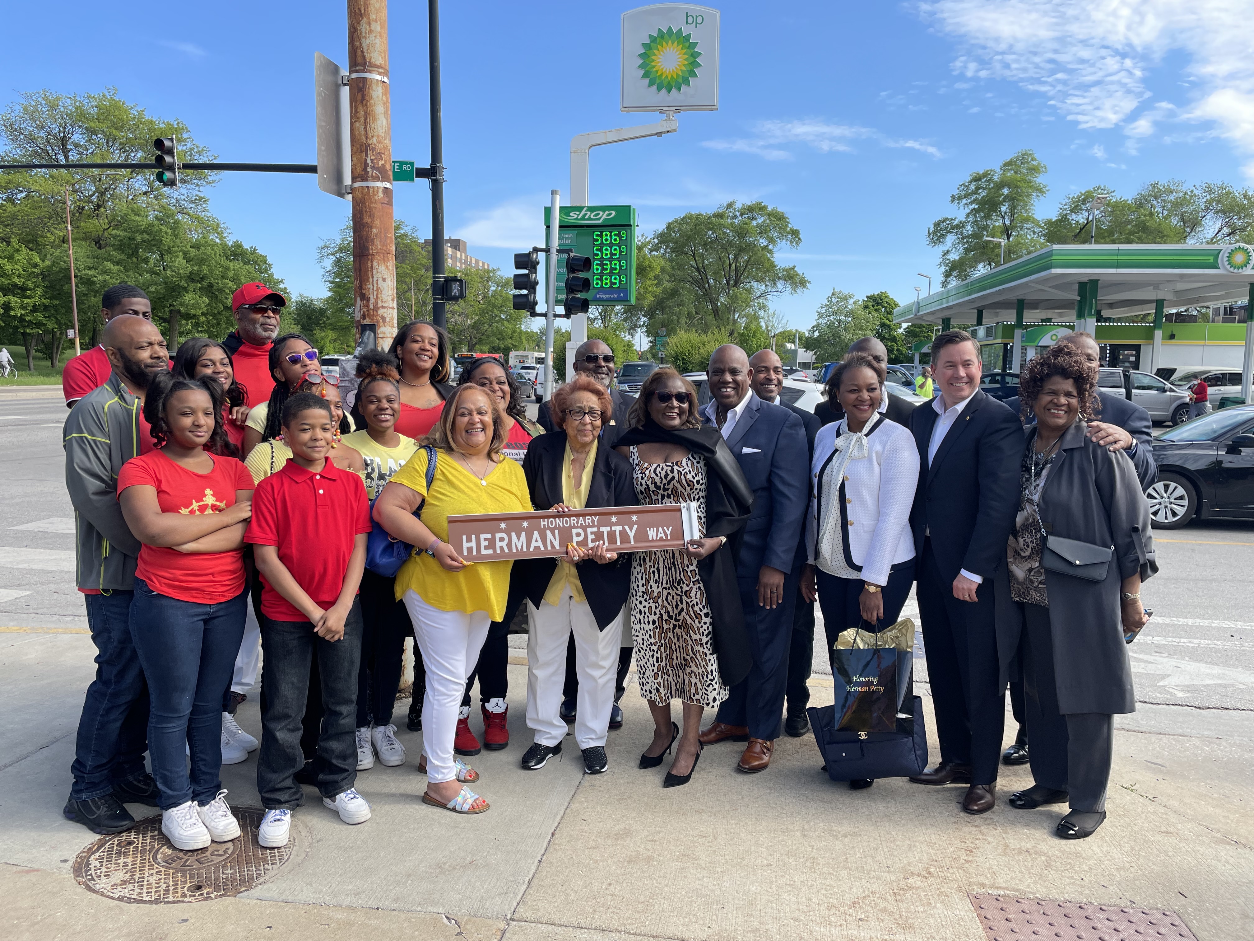 Petty Family holding Herman Petty Way street sign