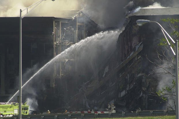 Fire crews work to put out the flames following the collapse of the E Ring, 11 September 2001