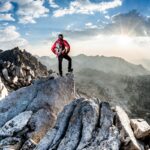 Mountaineer taking in the view from top of the summit.