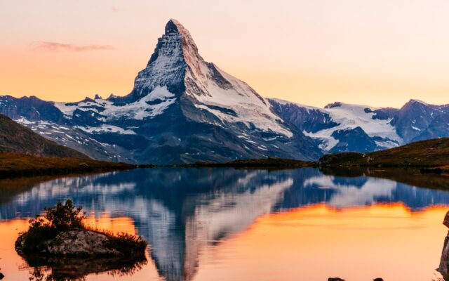 The Matterhorn mountain in the Swiss Alps, with reflection on a nearby lake.