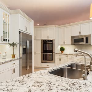 Kitchen sink with appliances and cabinets in background