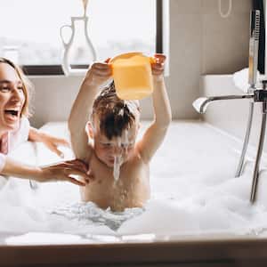 Mother and son playing in bathtub