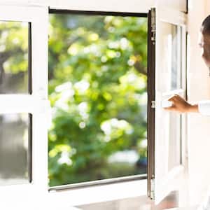 Man opening window letting fresh air in his house
