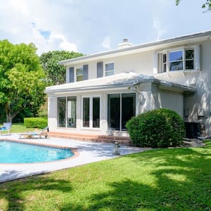 A modern two story house with a swimming pool