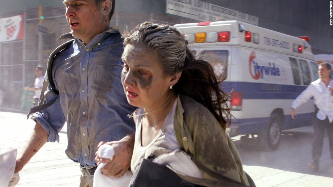 Dust-covered survivors run through New York&#39;s streets after the towers collapsed.