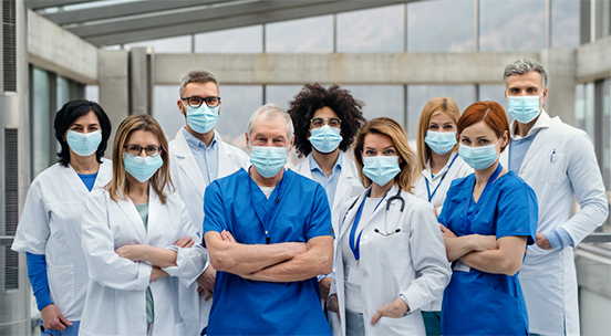 Group of health professionals wearing masks and looking at the camera