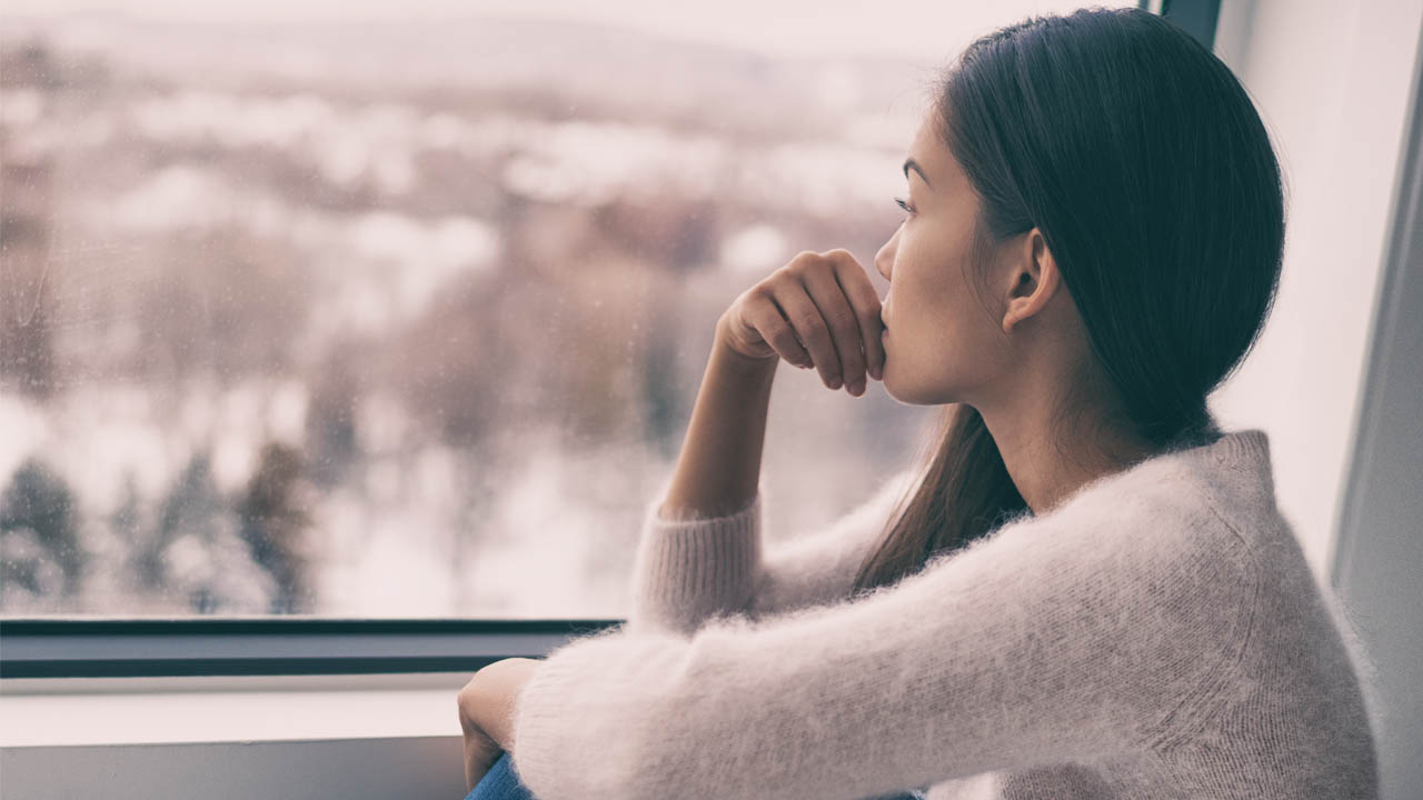 woman staring out of a window