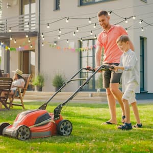 Father and son mowing the lawn