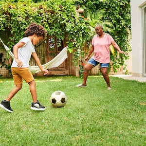 Grandmother and child playing soccer